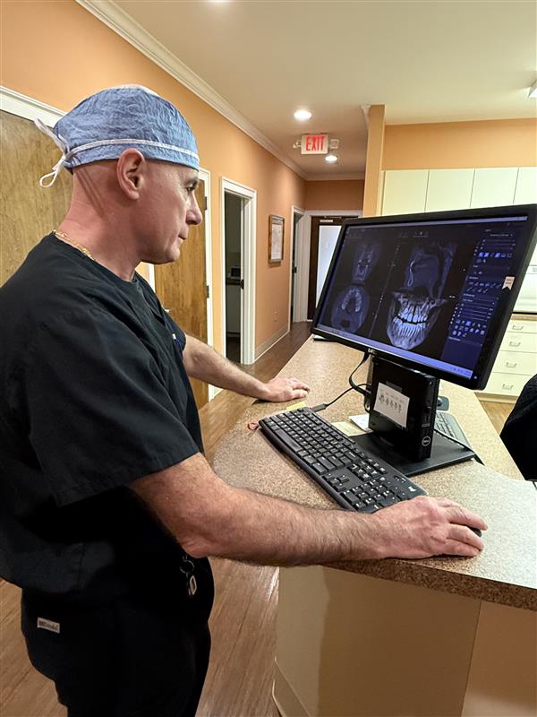 Dr. Patrick A. Scioscia examining digital x-rays on a computer